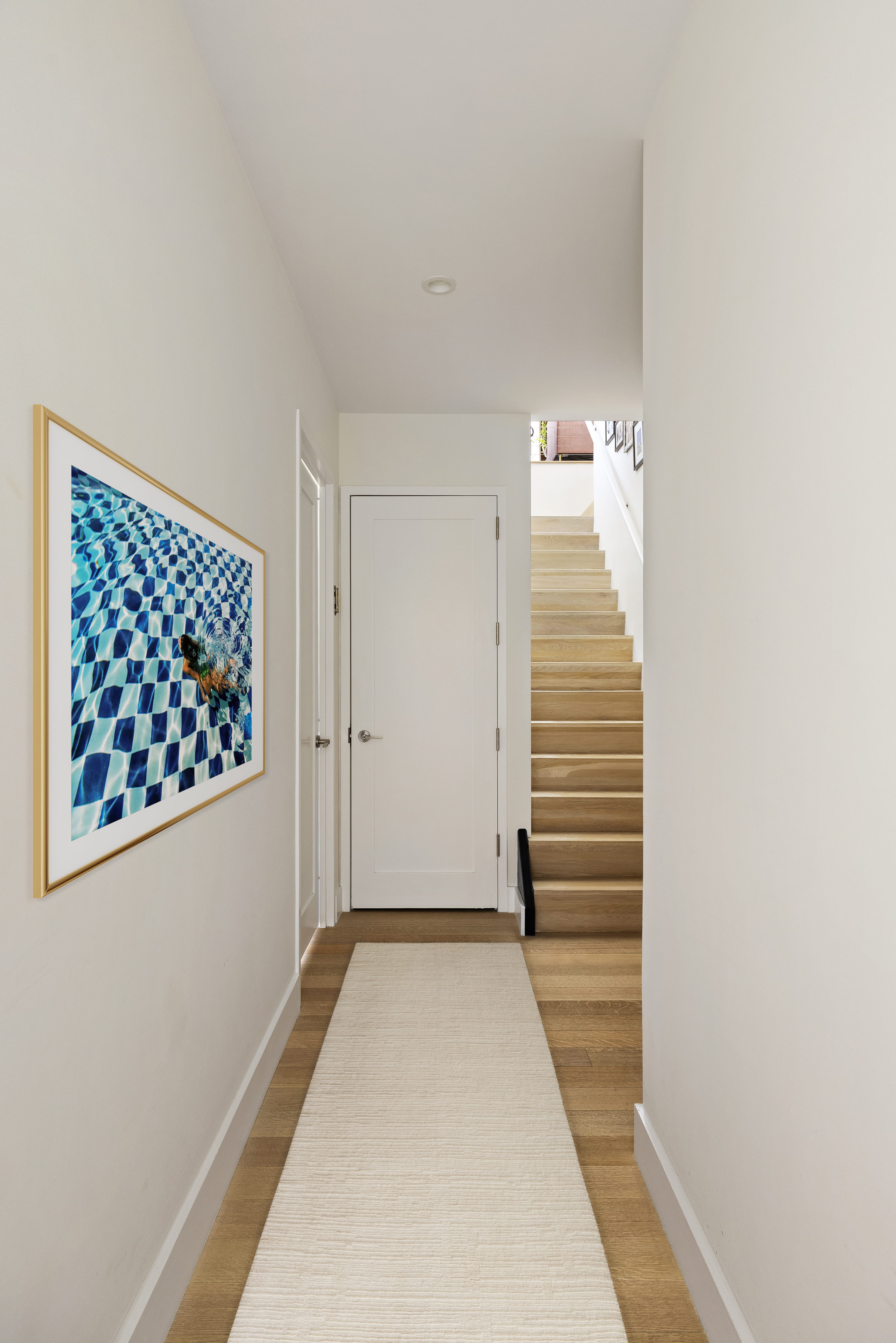 Interior staircase connecting the two levels of the duplex penthouse