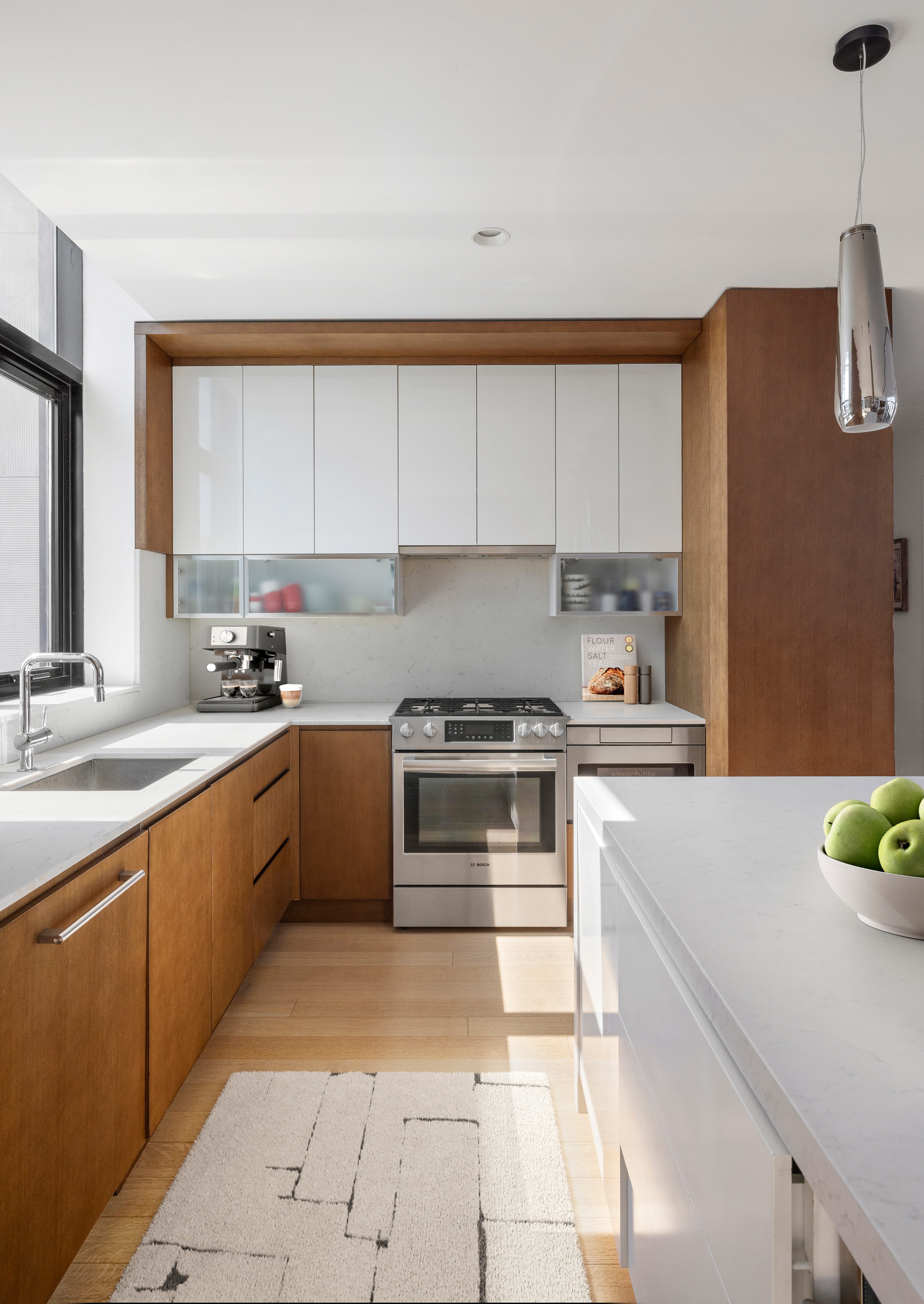 Kitchen island with pendant lighting and skyline views