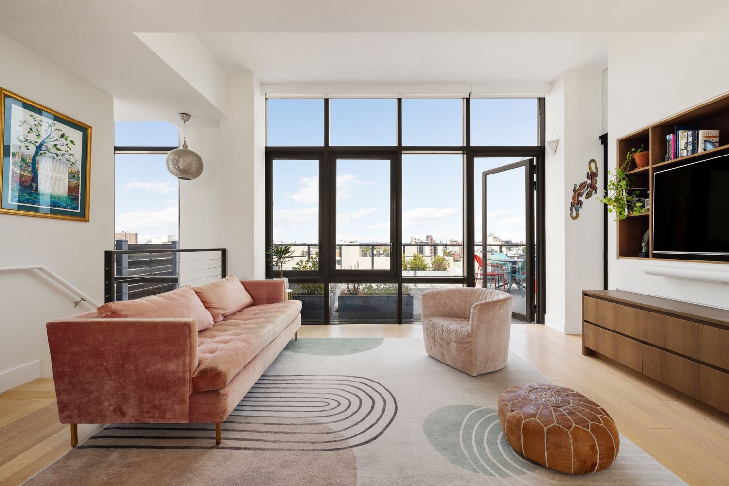 Living room with double height windows opening to the west terrace