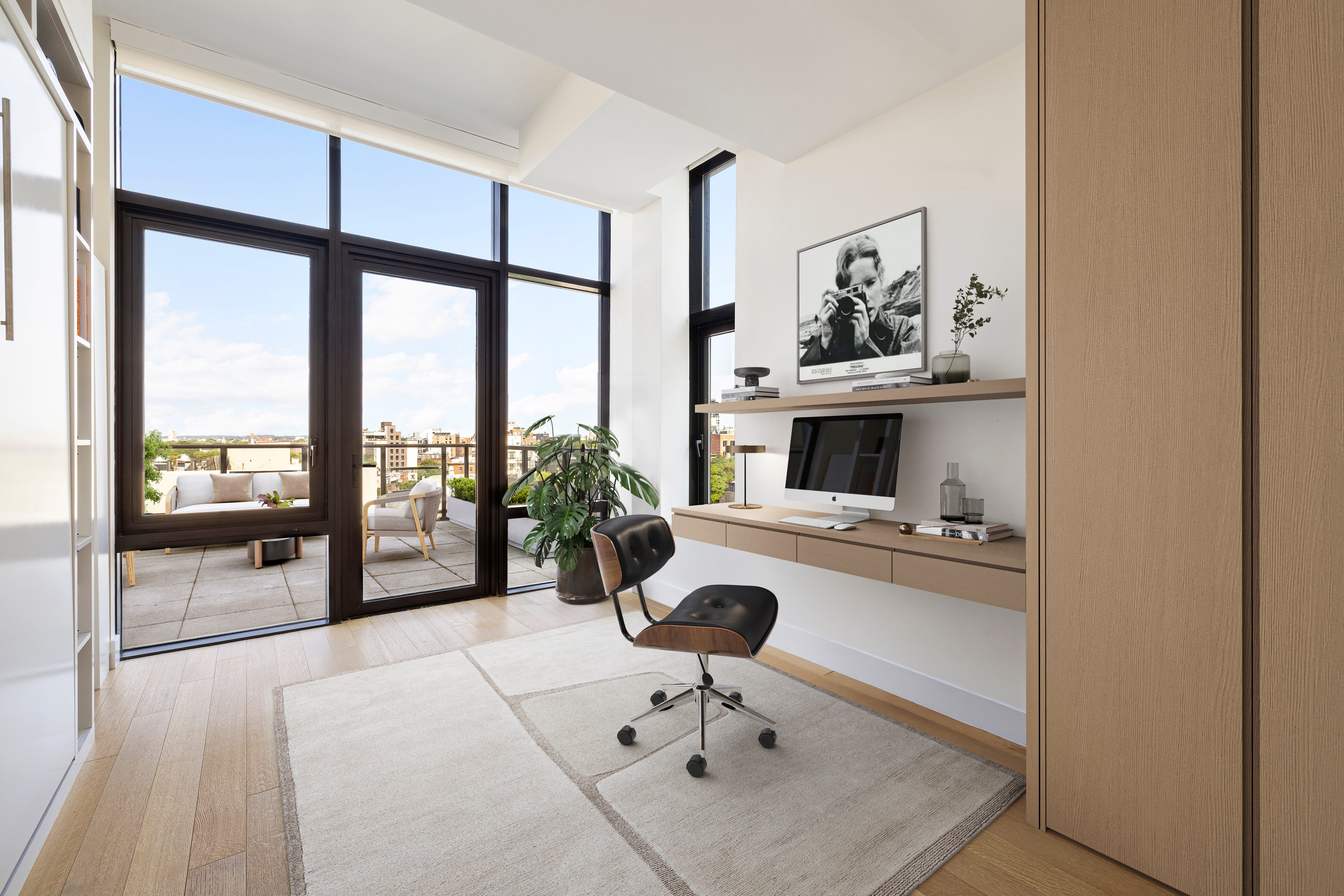 Home office with floating desk and terrace views